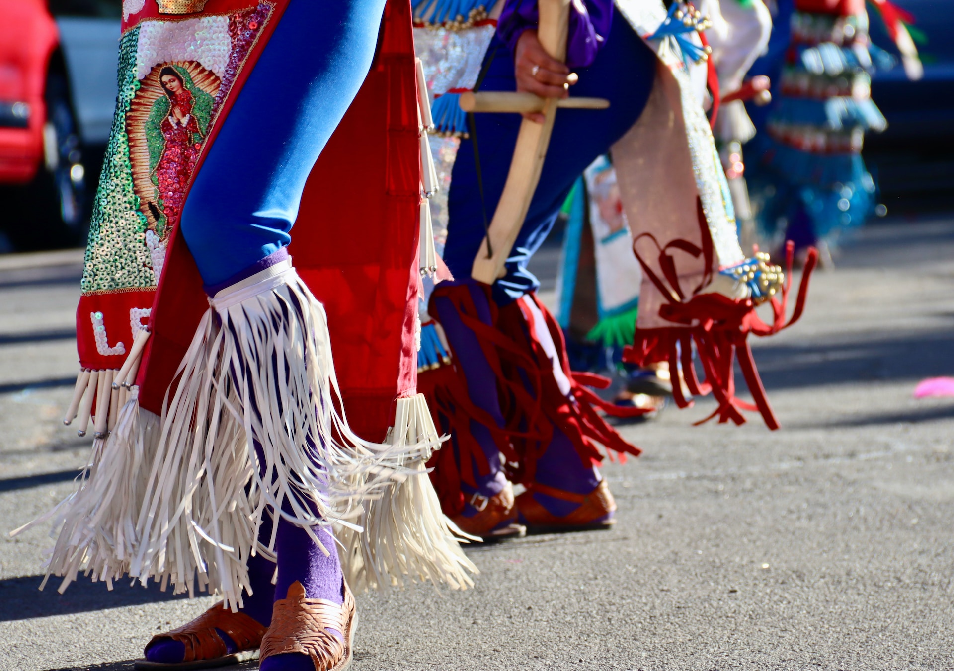 Woman in blue and red long sleeve dress walking on street during daytime.